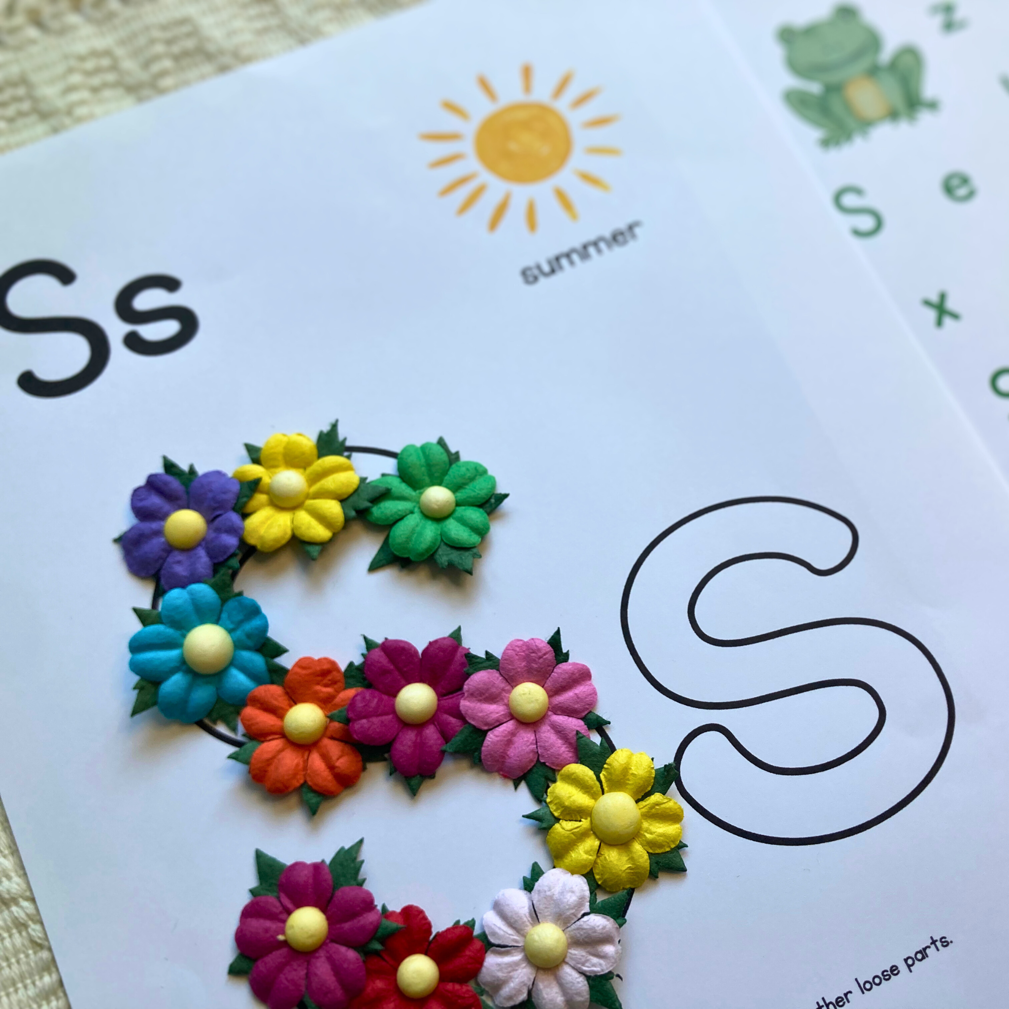 Tinker tray with seashells, sun, frog, and summer craft supplies from preschool homeschool box
