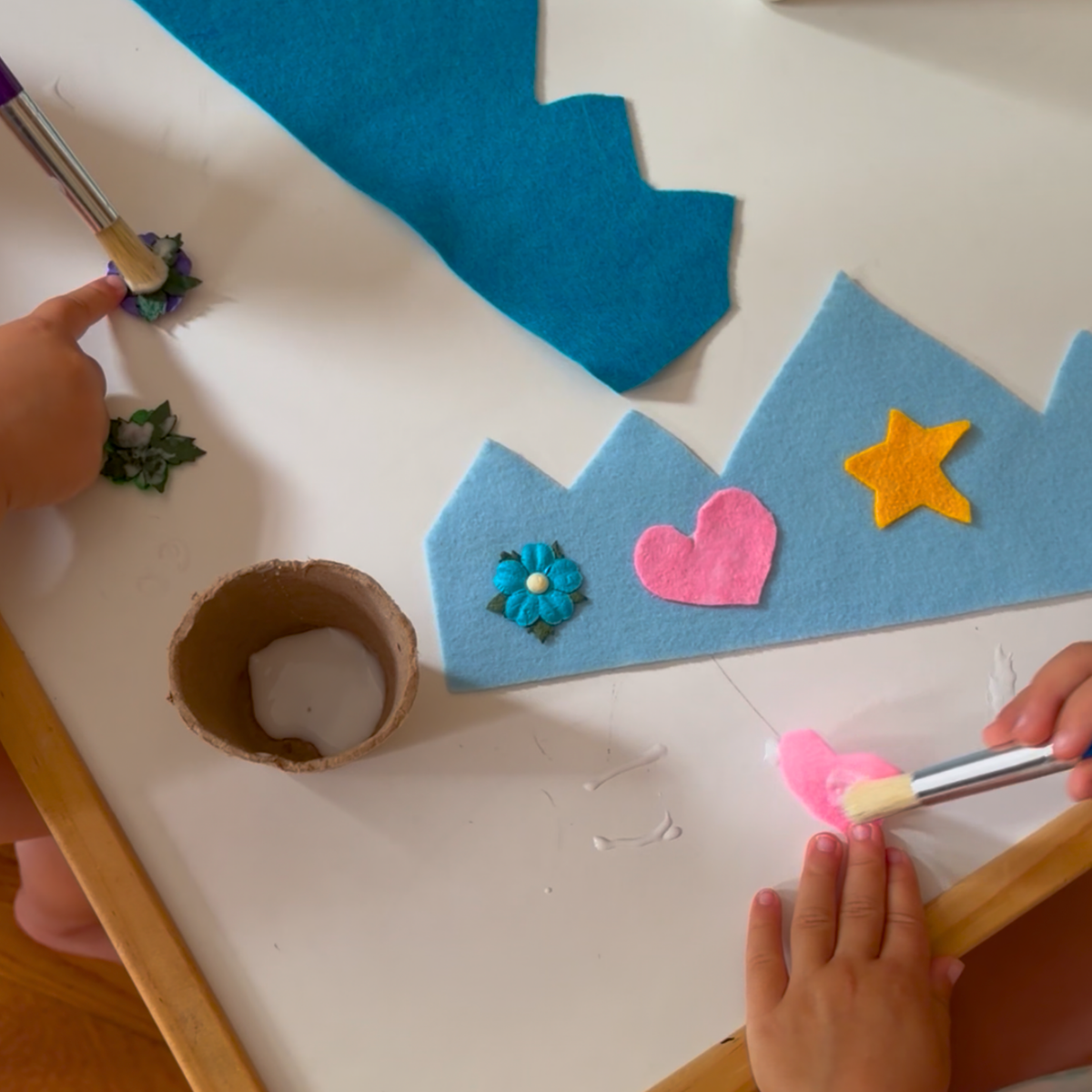 Children creating confidence crowns during a Jabari Jumps preschool activity.