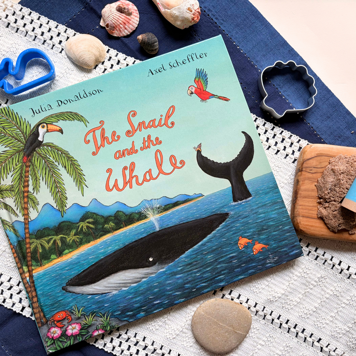 The Snail and the Whale picture book styled with ocean-themed materials for story-led preschool learning.
