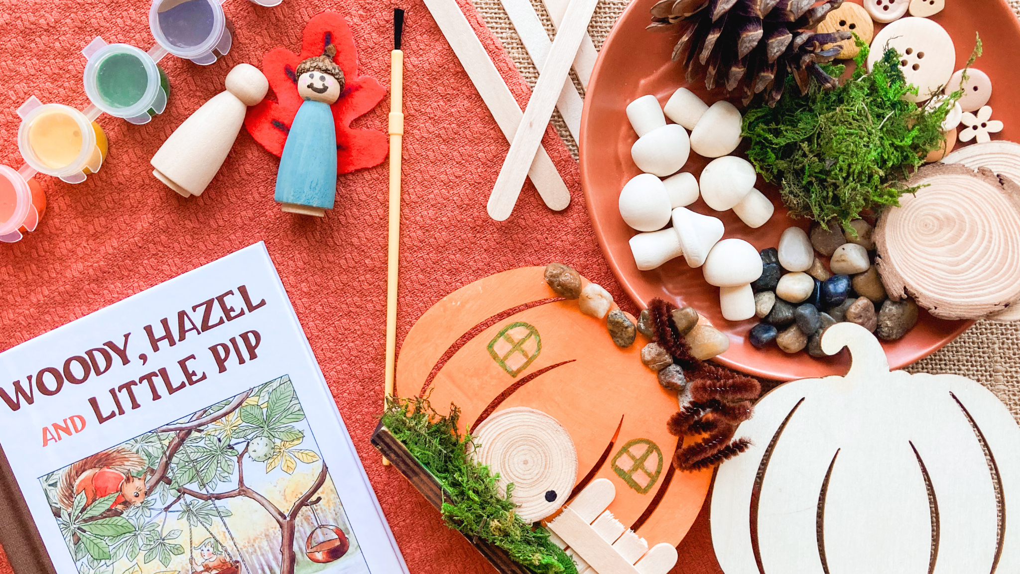 Woody, Hazel and Little Pip book with autumn nature play materials including wooden mushrooms, moss, pinecone, peg dolls, and pumpkin craft for fall literature-based homeschool learning