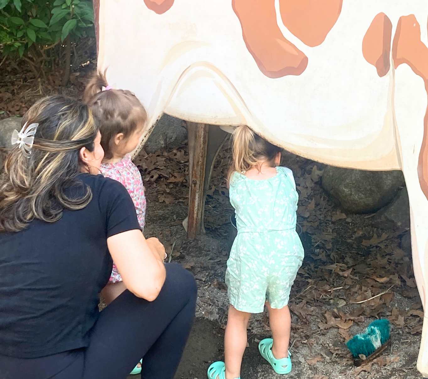 A mother and her two young daughters explore together, encouraging curiosity and child-led learning through everyday discovery.