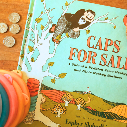Caps for Sale by Esphyr Slobodkina styled with colorful stacking hats and counting pieces.