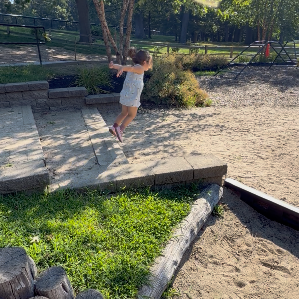 Child jumping outdoors during a movement activity inspired by Jabari Jumps.