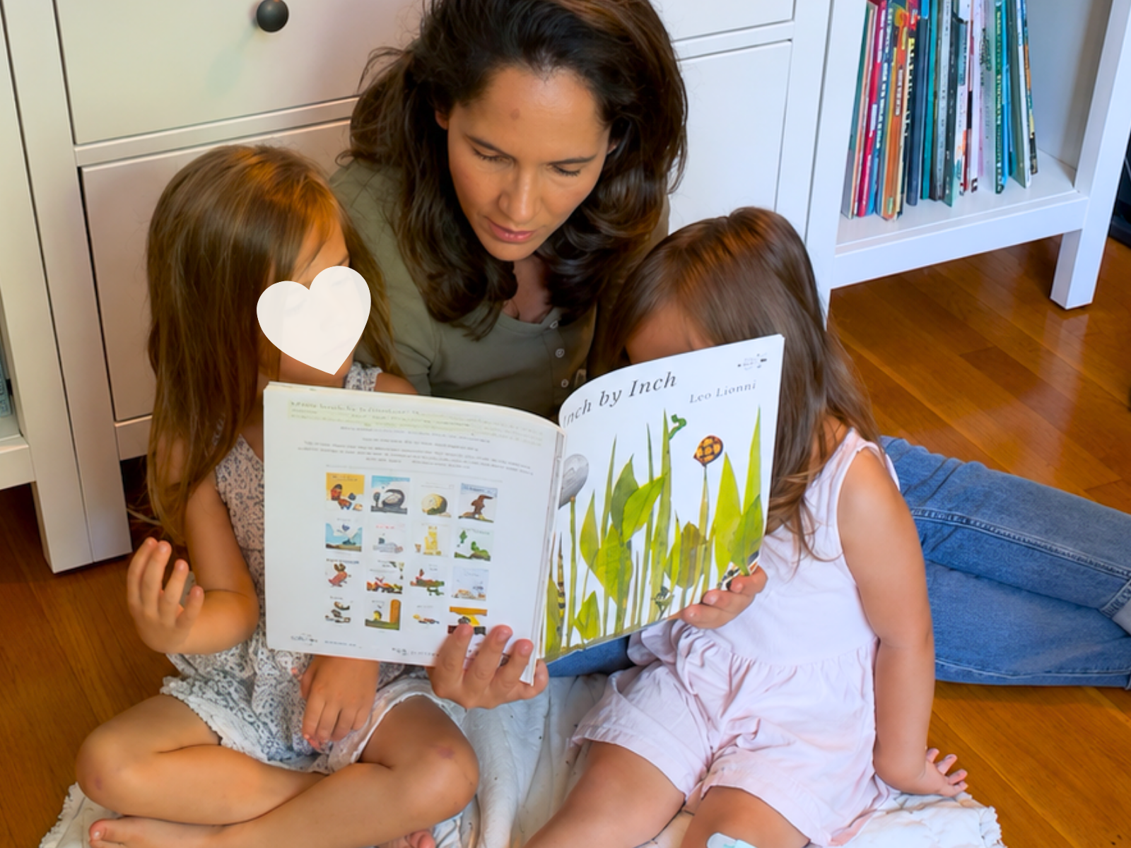 Mom reading Inch by Inch with two young children alongside an Acorn to Sprout preschool learning guide.
