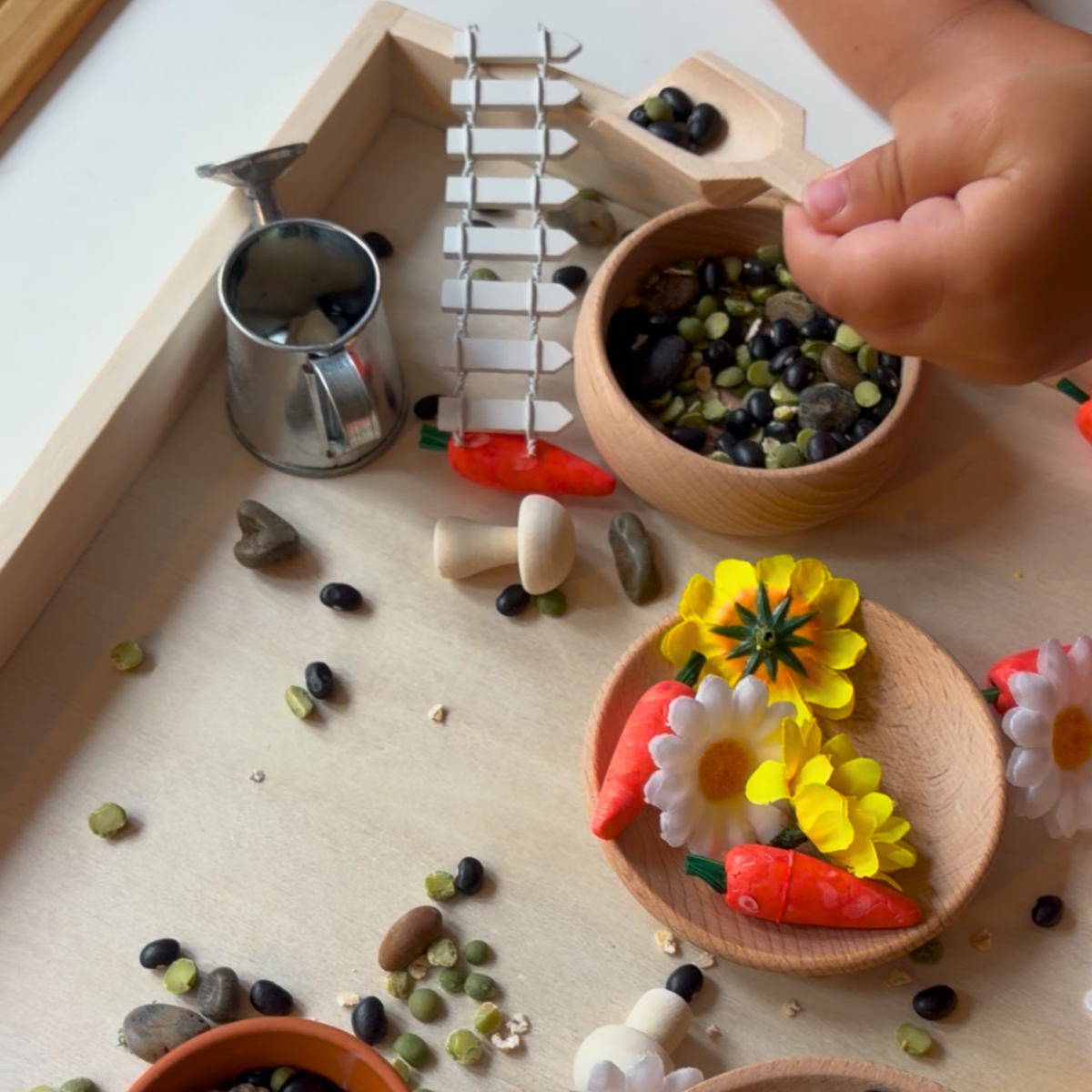 Garden-themed small world play with seeds, flowers, and natural materials.